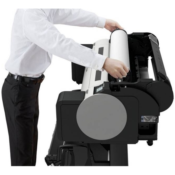 Man loading a roll of paper into a Canon TM-300